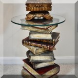F11. Stacked books end table with glass top. Designed & sculpted by Jaimy. 21”h x 16”w 
